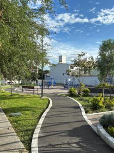 a winding walkway in a park with a bench at House check-in anytime after 3 pm in Jurica