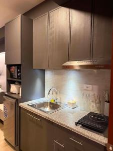 a kitchen with a sink and a counter top at D&J Cozy Family Studio Bacolod City in Bacolod