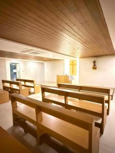 a church with benches and a table in a room at D&J Cozy Family Studio Bacolod City in Bacolod +11 photos