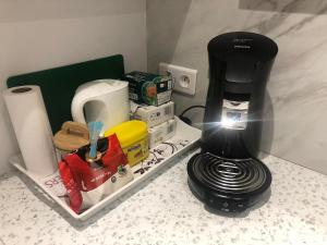 a black coffee maker sitting on top of a counter at Sci ZLR in Saint-Étienne +11 photos