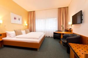 Postel nebo postele na pokoji v ubytování Hotel am Borsigturm