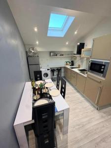 a kitchen with a table and chairs and a window at Sci ZLR in Saint-Étienne
