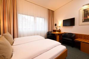 Postel nebo postele na pokoji v ubytování Hotel am Borsigturm