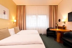 Postel nebo postele na pokoji v ubytování Hotel am Borsigturm