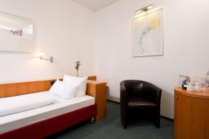 Postel nebo postele na pokoji v ubytování Hotel am Borsigturm