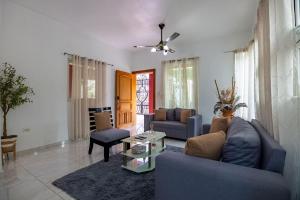 a living room with a couch and a table at Cozy home in puerto plata in San Felipe de Puerto Plata