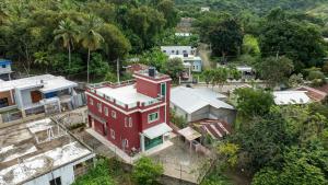an aerial view of a red house in a village at Cozy home in puerto plata in San Felipe de Puerto Plata