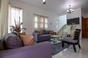 a living room with a couch and a chair at Cozy home in puerto plata in San Felipe de Puerto Plata