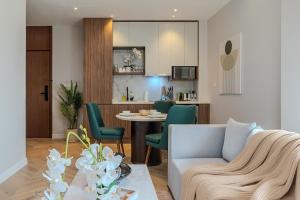 a living room with a couch and a table at Stella Stays King Fahd - Furnished Apartments in Riyadh
