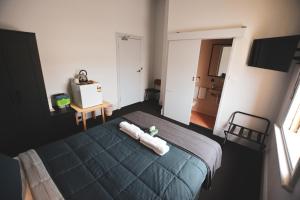 a bedroom with a bed with two towels on it at Queenscliffe Hotel in Kingscote