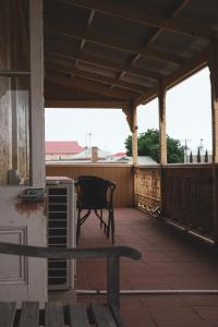 a patio with a bench on a porch at Queenscliffe Hotel in Kingscote +11 photos