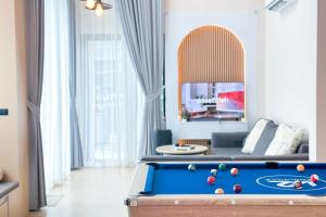 a living room with a pool table and a couch at K2 Pool Villa Khaoyai in Ban Sap Setthi
