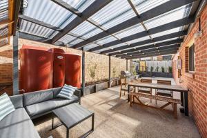 a patio with a couch and a table at Modern home in Highton in Highton
