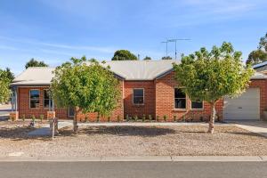 a brick house with two trees in front of it at Modern home in Highton in Highton