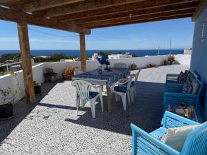a table and chairs on a patio with a view of the ocean at Ponzamania Terrazza sul tramonto in Ponza