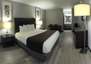 a bedroom with a large bed and two lamps at Western Inn in Forest Park