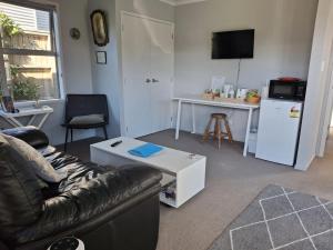 a living room with a couch and a table at The Coop in Kinloch
