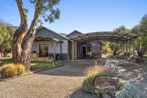 a building with an archway in front of it at Kickenback Lodge - 3BR Lodge l Gym l Indoor Pool l Tennis l WiFi l Air-Con in Crackenback