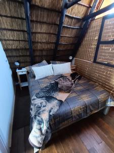 a large bed in a room with a roof at Cosy Cottage in Buffelspoort +46 photos