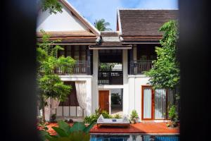 a house with a computer in front of it at Le Sen Boutique Hotel in Luang Prabang