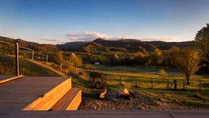 a fire pit with a view of the mountains at The Tiny House in Râşnov +8 photos