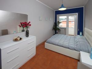 ローマにあるAlice Homeのベッドルーム1室(ベッド1台、花の飾られたドレッサー付)