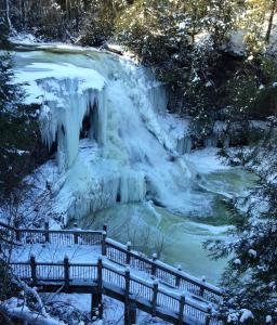 a waterfall covered in snow next to a river at Oak Mar Motel in Oakland