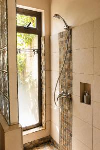 a bathroom with a shower and a window at Gite des Acacias in Union Vale +29 photos