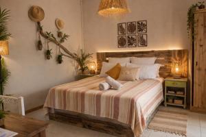 a bedroom with a bed with two pillows on it at Gite des Acacias in Union Vale