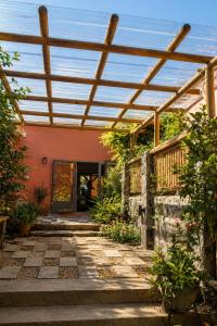an outside view of a house with a pergola at Gite des Acacias in Union Vale