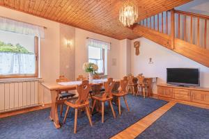 a dining room with a table and chairs and a television at House Marija with BBQ & Garden - Happy Rentals in Gradišča