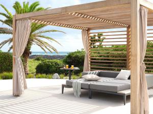a pergola with a couch on a patio at Haevichi Hotel & Resort Jeju in Seogwipo