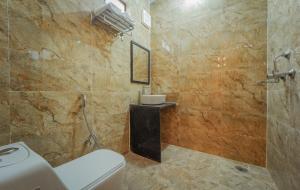 a bathroom with a toilet and a shower at The Amber House - Luxury Boutique Stay in Bani Park, City Center Jaipur in Jaipur +27 photos