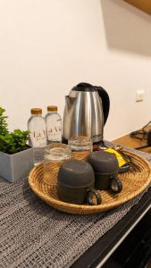 a tray with a tea kettle and other items on a counter at La Vie Résidence in Chiang Mai