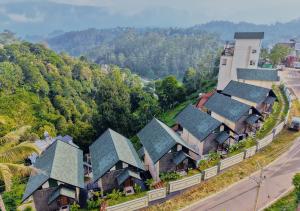 an overhead view of a row of houses with trees at Nature Green Pool Resort Munnar by VOYE HOMES in Munnar