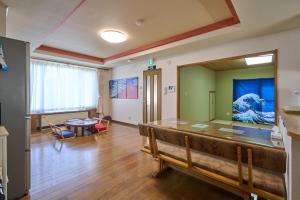 a living room with a bench and a table at Sapporo Vacation Home B&B in Sapporo