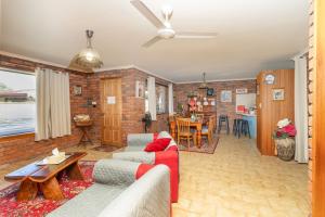 a living room with a couch and a table at Bromeliads in Iluka