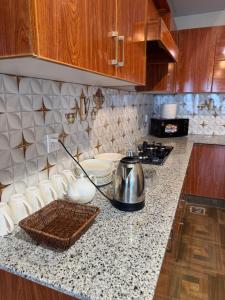 a kitchen with a counter top with a tea kettle on it at Capresso Homes 4 in Islamabad