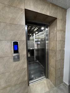 an elevator in a building with a sign on the wall at Capresso Homes 4 in Islamabad