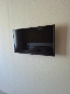 a flat screen tv hanging on a wall at Poilsis dviems in Šiauliai