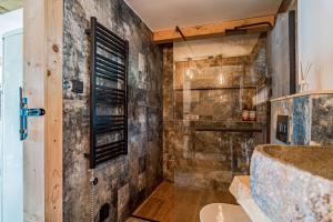 a bathroom with a shower and a tub at Chata Malenovice in Malenovice