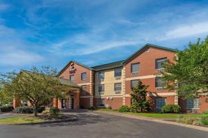 an apartment building with a street in front at Comfort Suites Pittsburgh Airport in Coraopolis