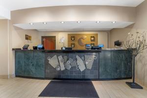 a lobby with a reception counter with shoes on it at Comfort Suites Pittsburgh Airport in Coraopolis +55 photos