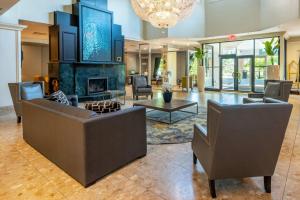 a living room with two couches and a fireplace at Chateau Cartier Hotel & Resort, an Ascend Collection Resort in Gatineau