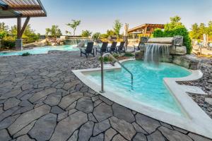 a hot tub with a waterfall in a yard at Chateau Cartier Hotel & Resort, an Ascend Collection Resort in Gatineau
