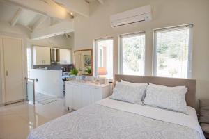 a bedroom with a large bed and a kitchen at Sunray Poros in Poros