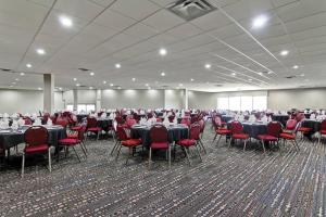a large banquet hall with tables and red chairs at Radisson Hotel & Conference Centre Edmonton in Edmonton