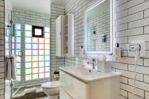 a white bathroom with a sink and a toilet at Comfort Suites Tijuana in Tijuana