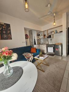 a living room with a vase of flowers on a table at Cindy's Ample home in Mombasa