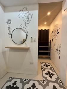 a bathroom with a mirror and a rug at Villas Transient Inn in San Juan